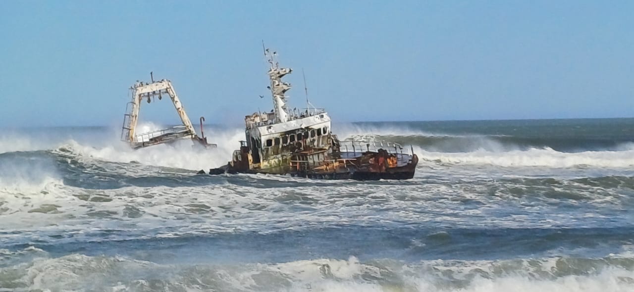 An offshore shipwreck surrounded by Atlantic surf, photographed on Gerhardt’s travels.